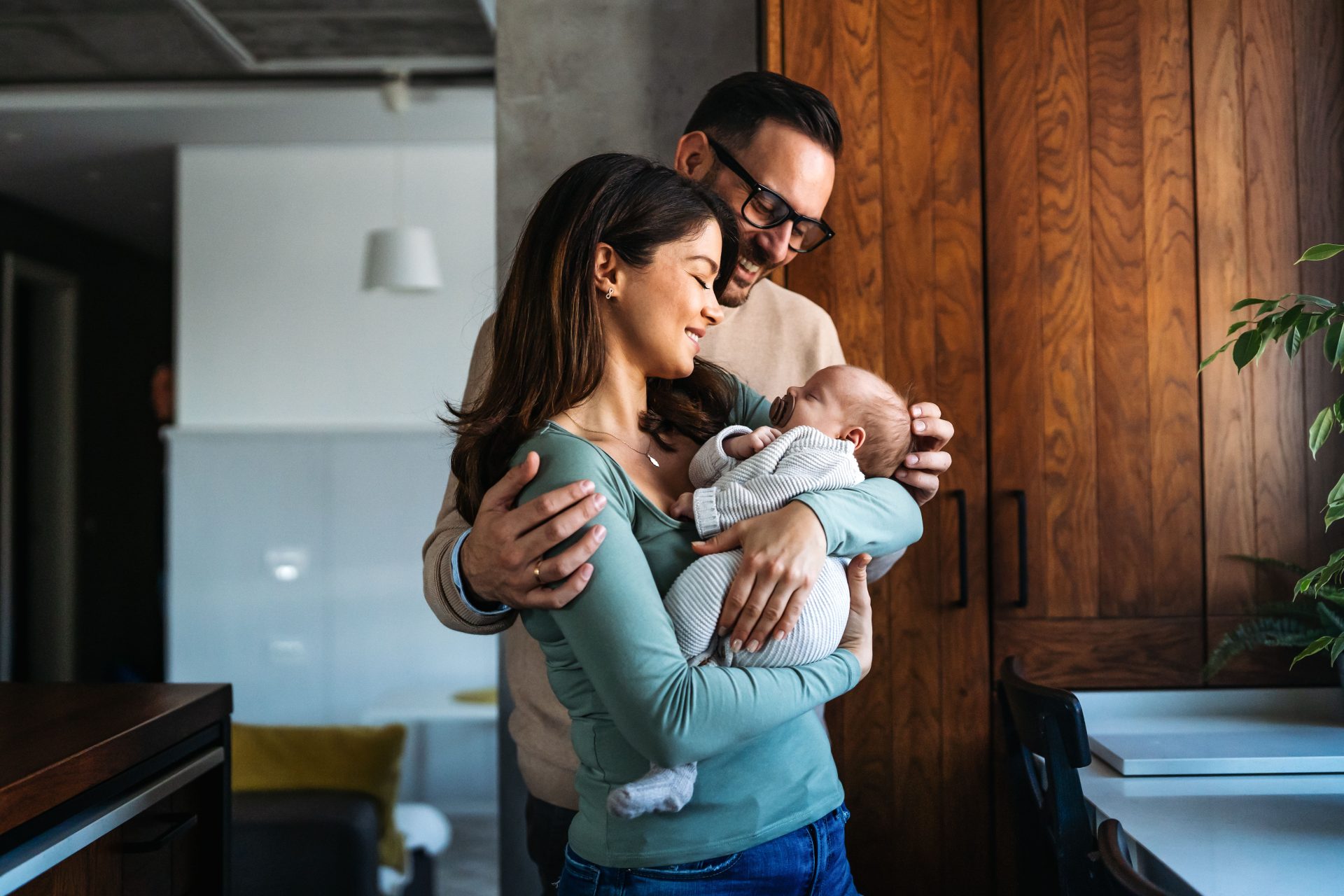 Couple holding newly adopted baby